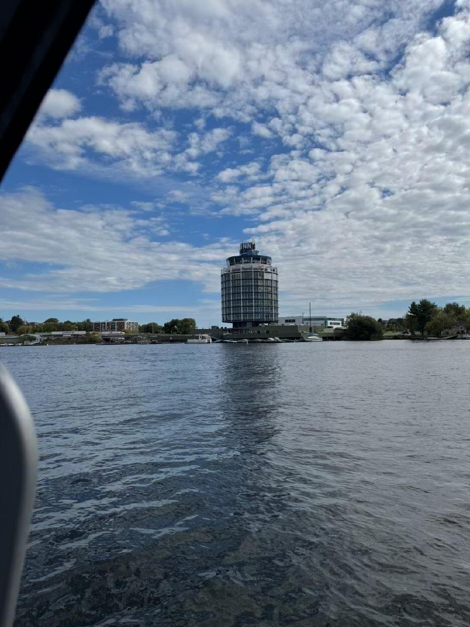 A round tower hotel on the Kenora waterfront seen from the water